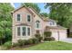 Charming two-story home featuring a well-manicured lawn, lush landscaping, and inviting curb appeal at 58 Parkside Cir, Marietta, GA 30068