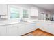 Bright kitchen features white cabinets, white countertops, stainless steel sink, and two windows providing natural light at 58 Parkside Cir, Marietta, GA 30068