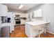 Bright kitchen featuring white cabinetry, modern appliances, and a convenient breakfast bar area at 58 Parkside Cir, Marietta, GA 30068