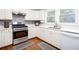 Functional kitchen with stainless steel appliances, white cabinets, and a window over the sink at 58 Parkside Cir, Marietta, GA 30068