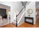 Bright foyer with a staircase featuring white railings and black spindles, complemented by hardwood floors at 58 Parkside Cir, Marietta, GA 30068