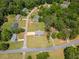 A lush, green neighborhood with mature trees surrounds this charming home with a long driveway and expansive lawn at 70 Heritage Way, Covington, GA 30016