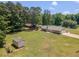 Aerial view of property including the house, shed, and surrounding trees at 70 Heritage Way, Covington, GA 30016
