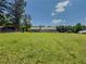 Large backyard and exterior view of the home and mature trees at 70 Heritage Way, Covington, GA 30016