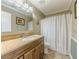 Cozy bathroom featuring a vanity with granite counters and framed mirror at 70 Heritage Way, Covington, GA 30016