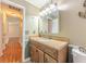 Bathroom featuring a vanity with granite counters and a mirrored cabinet at 70 Heritage Way, Covington, GA 30016