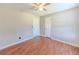 A bedroom featuring hardwood flooring and a ceiling fan at 70 Heritage Way, Covington, GA 30016
