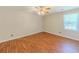 A bedroom features hardwood floors, a ceiling fan, and natural light at 70 Heritage Way, Covington, GA 30016