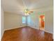 Bright bedroom with hardwood floors, a ceiling fan, and access to a bathroom for added convenience at 70 Heritage Way, Covington, GA 30016