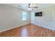 A bedroom features hardwood floors, ceiling fan, and a mounted TV at 70 Heritage Way, Covington, GA 30016
