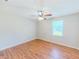 Bedroom with natural light, featuring hardwood flooring and a ceiling fan at 70 Heritage Way, Covington, GA 30016