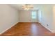 Spacious bedroom with hardwood flooring, a ceiling fan, and ample natural light for a comfortable living space at 70 Heritage Way, Covington, GA 30016