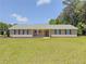 Beautiful ranch-style home with a covered front porch and lush green lawn at 70 Heritage Way, Covington, GA 30016