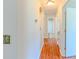 Inviting hallway with hardwood floors, neutral walls, and access to various rooms within the home at 70 Heritage Way, Covington, GA 30016