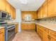 Bright kitchen with wooden cabinets, sleek appliances, and ample counter space for meal preparation at 70 Heritage Way, Covington, GA 30016
