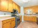 Spacious kitchen equipped with wooden cabinets, modern appliances, and tiled backsplash for a stylish look at 70 Heritage Way, Covington, GA 30016