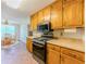 Well-lit kitchen showcasing wood cabinets, stainless steel appliances, and a view into the breakfast nook at 70 Heritage Way, Covington, GA 30016