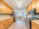 Extended kitchen view showcasing cabinetry, appliances, and seamless connection to the dining area for entertaining at 70 Heritage Way, Covington, GA 30016