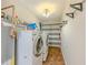 Functional laundry room featuring a washer, dryer, storage shelves, and essential utilities for convenience at 70 Heritage Way, Covington, GA 30016