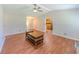 Spacious living room with hardwood floors, ceiling fan, and access to the kitchen and front door at 70 Heritage Way, Covington, GA 30016