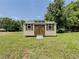 Yard with shed featuring carriage doors at 70 Heritage Way, Covington, GA 30016
