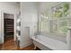 Bright bathroom with a clawfoot tub and large windows, offering a relaxing and spa-like experience at 1066 High Point Ne Dr, Atlanta, GA 30306
