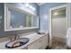 Stylish bathroom featuring a large mirror, custom vanities and fixtures, and a tub shower at 1066 High Point Ne Dr, Atlanta, GA 30306