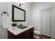 Bathroom featuring vanity with granite countertop, decorative mirror and adjacent toilet at 1066 High Point Ne Dr, Atlanta, GA 30306