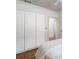 Bedroom featuring a large closet with classic white doors and hardwood floors at 1066 High Point Ne Dr, Atlanta, GA 30306
