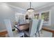 Light filled dining room with wood table, seating for six and a view into the living room at 1066 High Point Ne Dr, Atlanta, GA 30306