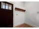 Entryway features dark wood door, coat rack, hardwood floors, and neutral paint at 1066 High Point Ne Dr, Atlanta, GA 30306