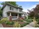 A side view of a beautifully landscaped two-story home with a cozy front porch at 1066 High Point Ne Dr, Atlanta, GA 30306