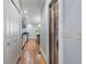 Hallway with hardwood floors leading to the kitchen and pantry with white doors at 1066 High Point Ne Dr, Atlanta, GA 30306