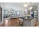 Open-concept kitchen features an island with granite counters, stainless steel appliances, and hardwood floors at 1066 High Point Ne Dr, Atlanta, GA 30306
