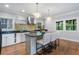 Kitchen with stainless steel appliances, a center island with seating and warm wood floors at 1066 High Point Ne Dr, Atlanta, GA 30306