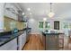Bright, modern kitchen features an island with barstool seating and hardwood floors at 1066 High Point Ne Dr, Atlanta, GA 30306