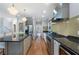 Galley style kitchen featuring granite countertops, stainless appliances and a view to the dining room at 1066 High Point Ne Dr, Atlanta, GA 30306
