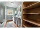 Bright laundry room featuring a washer, dryer, storage, and a sink area at 1066 High Point Ne Dr, Atlanta, GA 30306