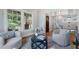 Bright living room with hardwood floors, neutral tones, and three cozy armchairs provides a serene atmosphere at 1066 High Point Ne Dr, Atlanta, GA 30306
