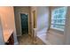Bathroom featuring a white tub, dark vanity, and a doorway leading to a walk-in closet at 2153 Pine View Trl, Ellenwood, GA 30294
