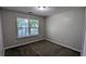 Bedroom with a window letting in natural light and neutral walls and carpet at 2153 Pine View Trl, Ellenwood, GA 30294