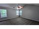 A primary bedroom with a high ceiling, a ceiling fan, and two windows that provide natural light at 2153 Pine View Trl, Ellenwood, GA 30294