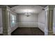 Formal dining room with carpet, wainscoting, and traditional chandelier at 2153 Pine View Trl, Ellenwood, GA 30294