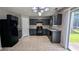 Well-lit kitchen with black appliances, light countertops, and ample cabinet space at 2153 Pine View Trl, Ellenwood, GA 30294