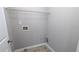 This laundry room has tile floors and a metal rack for storage and organization at 2153 Pine View Trl, Ellenwood, GA 30294