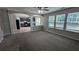 Spacious living room with multiple windows offering ample natural light, seamlessly connected to the kitchen at 2153 Pine View Trl, Ellenwood, GA 30294