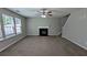 Spacious living room features fireplace, neutral carpet, and bright windows at 2153 Pine View Trl, Ellenwood, GA 30294