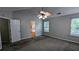 The primary bedroom boasts a ceiling fan, two windows, a bathroom entrance, and plush carpet at 2153 Pine View Trl, Ellenwood, GA 30294