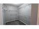 Spacious walk-in closet featuring built-in shelving and neutral carpet at 2153 Pine View Trl, Ellenwood, GA 30294