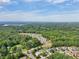 Scenic aerial view of a community surrounded by lush trees, showcasing a two-story home at 251 Parc Dr, Canton, GA 30114